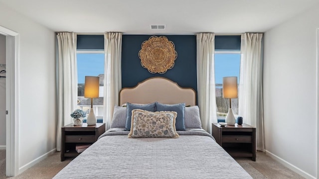 carpeted bedroom featuring baseboards