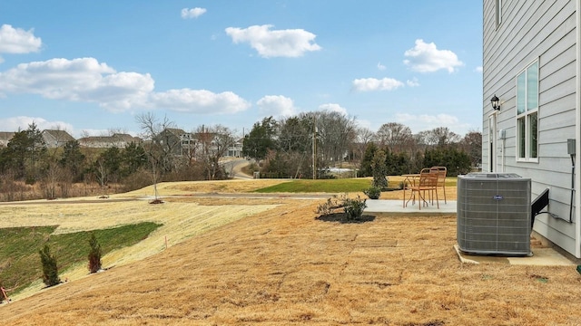 view of yard with central AC and a patio area