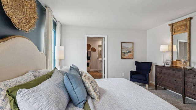 carpeted bedroom with baseboards and ensuite bathroom