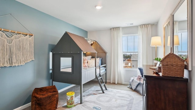 carpeted bedroom featuring baseboards