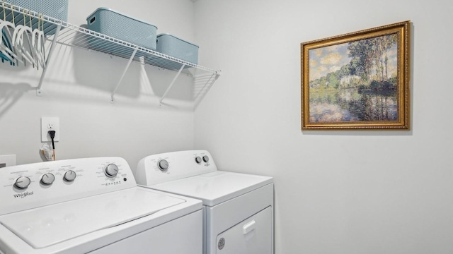 clothes washing area featuring washer and dryer
