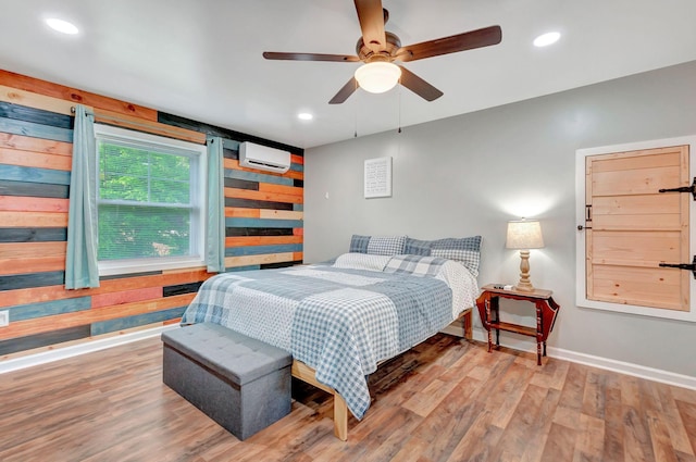 517 Main St, Burns, TN 37029 - bedroom featuring a wall mounted air conditioner, wood finished floors, baseboards, recessed lighting, and wood walls