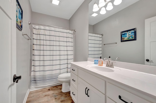 517 Main St, Burns, TN 37029 - full bath featuring wood finished floors, toilet, and vanity