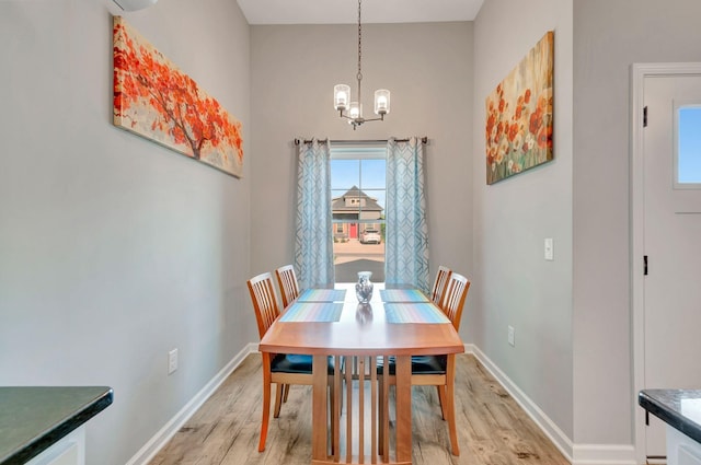 517 Main St, Burns, TN 37029 - dining room featuring a chandelier, light wood-style floors, baseboards, and a high ceiling