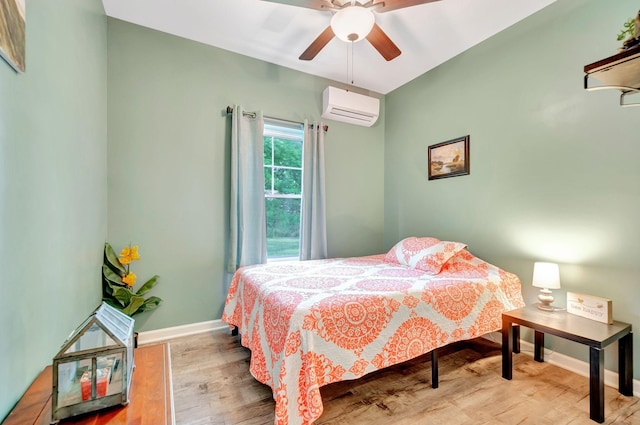 517 Main St, Burns, TN 37029 - bedroom with a wall unit AC, wood finished floors, baseboards, and ceiling fan