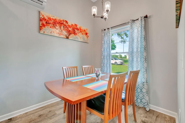 517 Main St, Burns, TN 37029 - dining area with a chandelier, light wood-type flooring, baseboards, and a wall mounted air conditioner