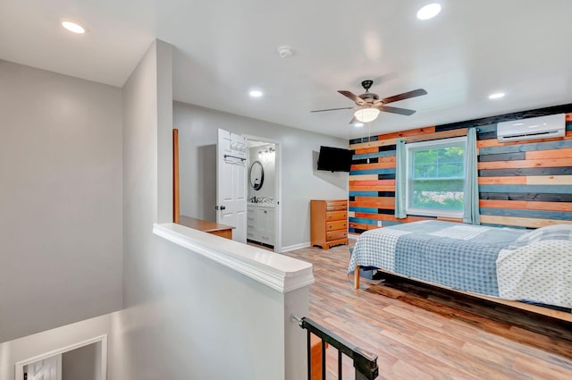 517 Main St, Burns, TN 37029 - bedroom with a wall unit AC, recessed lighting, wood finished floors, baseboards, and ensuite bath