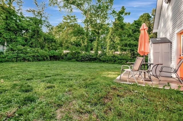 517 Main St, Burns, TN 37029 - view of grassy yard with a storage shed, an outbuilding, and view of wooded area