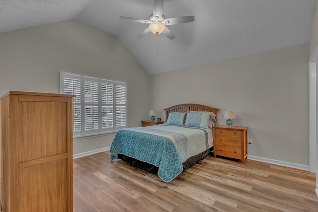 bedroom with vaulted ceiling, baseboards, wood finished floors, and ceiling fan