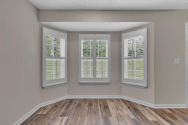 empty room with wood finished floors and baseboards
