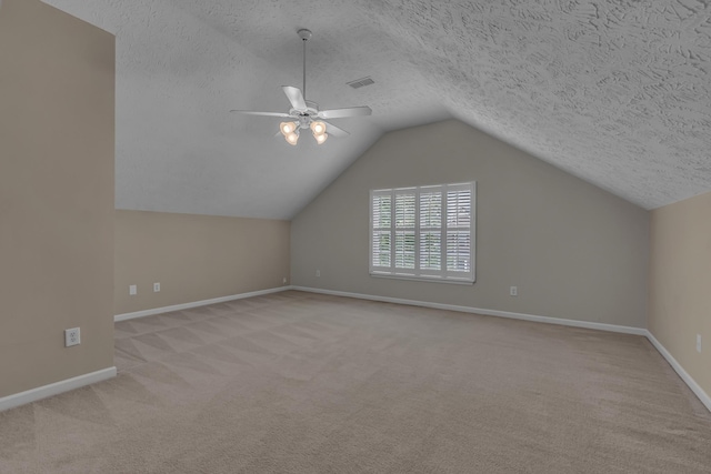 bonus room with carpet, baseboards, a ceiling fan, a textured ceiling, and vaulted ceiling
