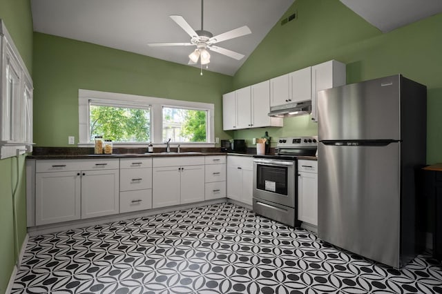 2001 E 16th St, Chattanooga, TN 37404 - kitchen with stainless steel appliances, under cabinet range hood, vaulted ceiling, white cabinets, and ceiling fan
