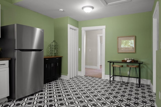 2001 E 16th St, Chattanooga, TN 37404 - kitchen featuring freestanding refrigerator, dark countertops, and white cabinets