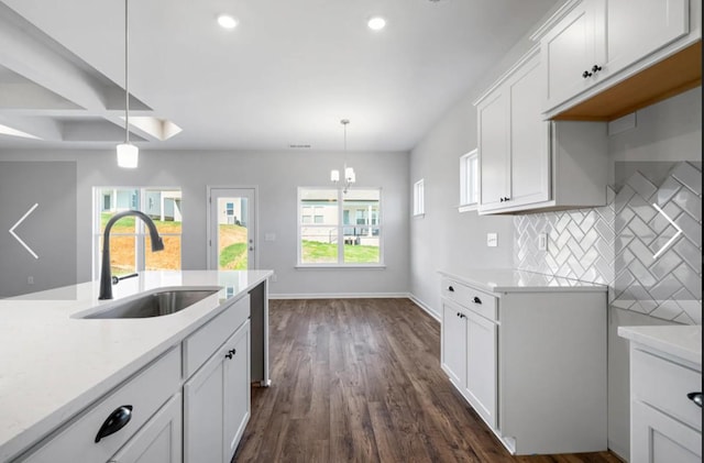 6152 Worthingtion, Columbia, TN 38401 - kitchen featuring a sink, light countertops, tasteful backsplash, dark wood-type flooring, and hanging light fixtures