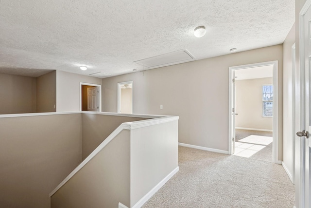 107 Owl Dr, Lebanon, TN 37087 - hall with attic access, an upstairs landing, carpet floors, a textured ceiling, and baseboards