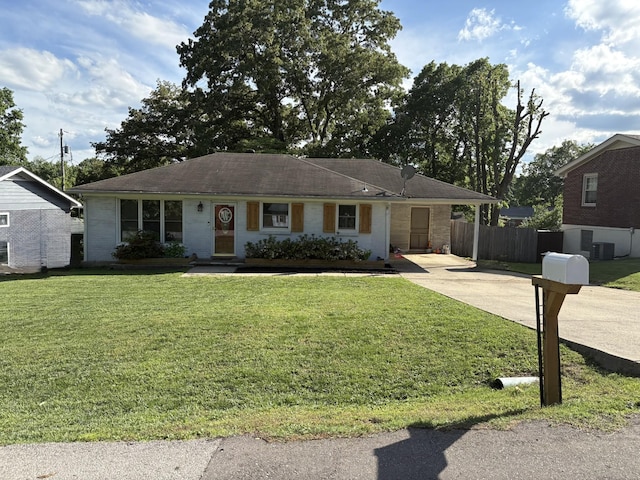 single story home featuring concrete driveway, an attached carport, and central AC unit