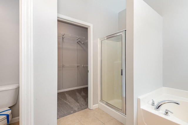 8007 Timber Cove Dr, Mount Juliet, TN 37122 - full bathroom with a stall shower, a spacious closet, tile patterned floors, a bath, and toilet