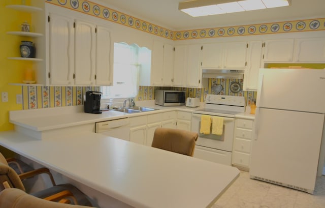 1210 Stewart Dr, Pulaski, TN 38478 - kitchen featuring white appliances, under cabinet range hood, a sink, a peninsula, and white cabinets
