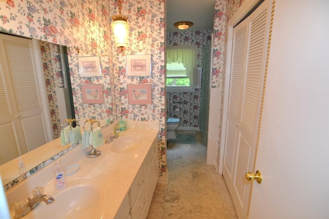 1210 Stewart Dr, Pulaski, TN 38478 - bathroom with a closet, wallpapered walls, toilet, and double vanity