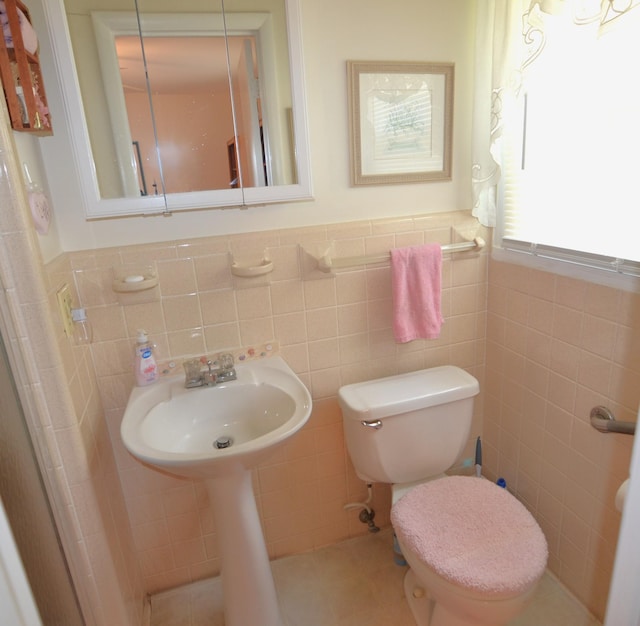 1210 Stewart Dr, Pulaski, TN 38478 - bathroom with tile walls, toilet, wainscoting, and a sink