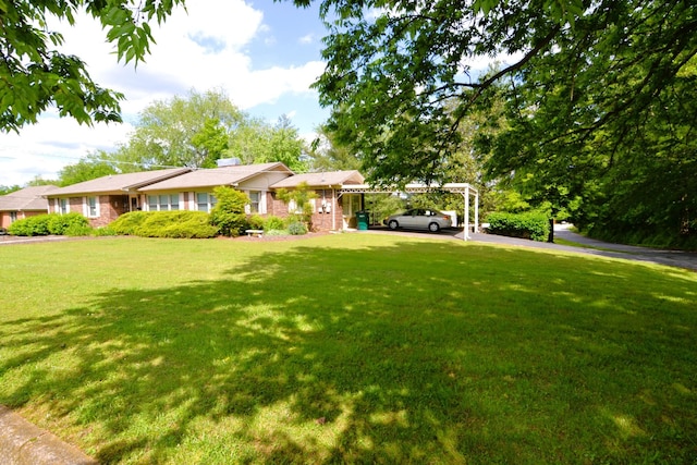 1210 Stewart Dr, Pulaski, TN 38478 - ranch-style home with a carport, a front yard, and a chimney