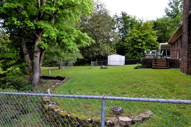 1210 Stewart Dr, Pulaski, TN 38478 - view of yard featuring a storage shed, an outbuilding, a deck, and stairs