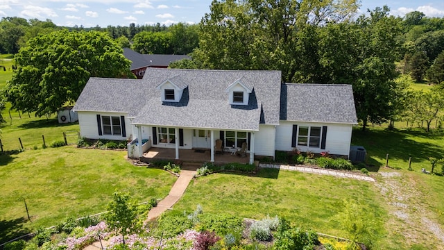 860 Dixie Bee Rd, Adams, TN 37010 - cape cod-style house featuring covered porch, roof with shingles, and cooling unit