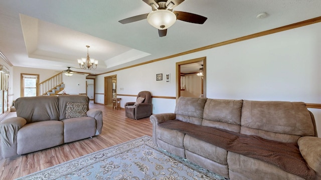 860 Dixie Bee Rd, Adams, TN 37010 - living area featuring a ceiling fan, a chandelier, wood finished floors, stairway, and a tray ceiling