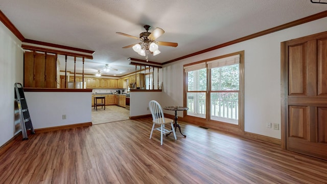 860 Dixie Bee Rd, Adams, TN 37010 - dining area featuring crown molding, light wood-style floors, ceiling fan, baseboards, and a textured ceiling