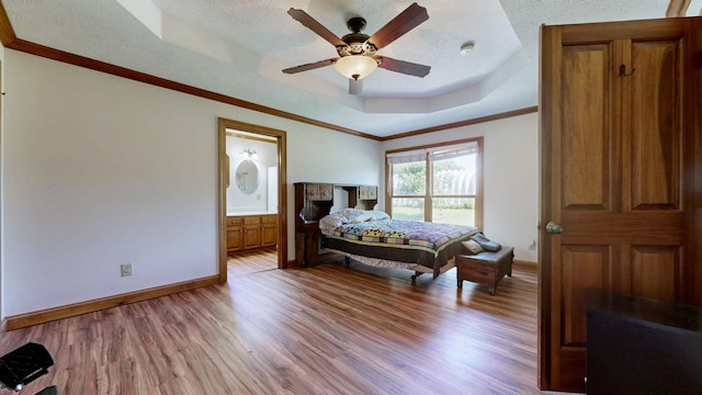 860 Dixie Bee Rd, Adams, TN 37010 - bedroom featuring a raised ceiling, wood finished floors, a textured ceiling, baseboards, and crown molding