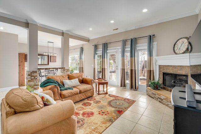 living room featuring light tile patterned flooring, recessed lighting, ornamental molding, and a tiled fireplace