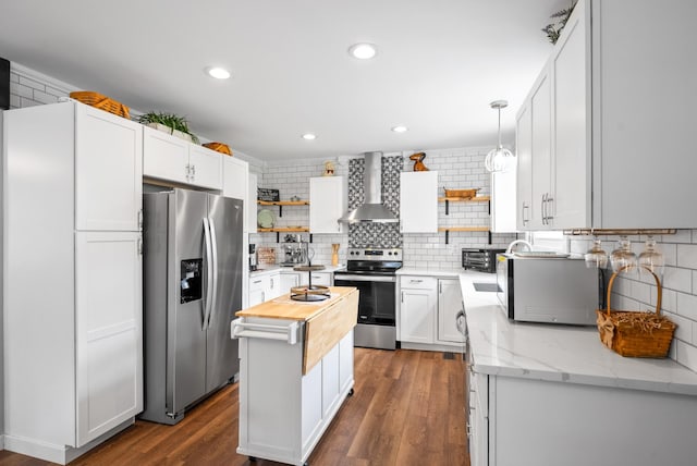 kitchen featuring appliances with stainless steel finishes, open shelves, wall chimney exhaust hood, wooden counters, and recessed lighting