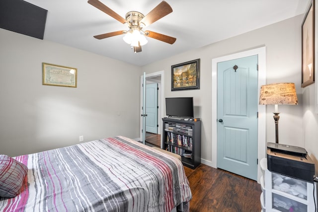 bedroom with wood finished floors, a ceiling fan, and baseboards