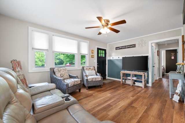 living room featuring attic access, ceiling fan, wood finished floors, and baseboards