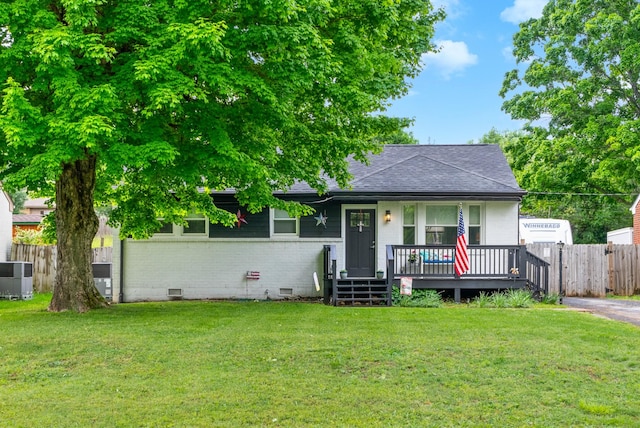 view of front of property with cooling unit, roof with shingles, brick siding, crawl space, and covered porch