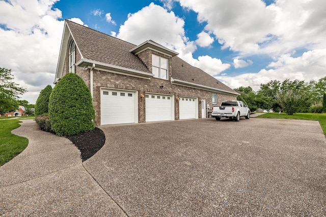 131 Grandview Cir, Gallatin, TN 37066 - view of home's exterior with a shingled roof, brick siding, asphalt driveway, and an attached garage