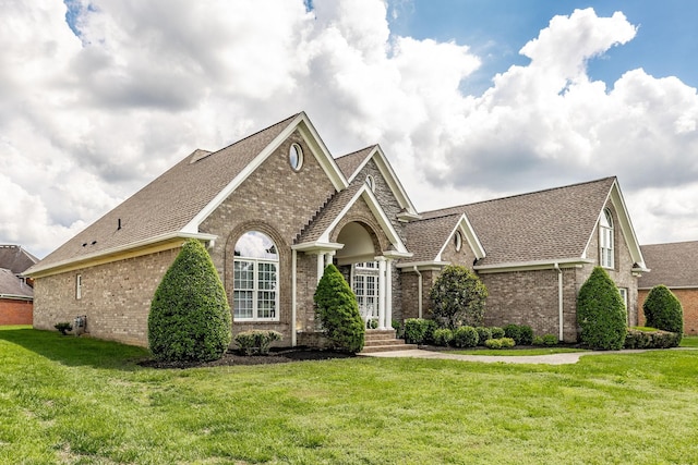 131 Grandview Cir, Gallatin, TN 37066 - view of front facade featuring brick siding, a front lawn, and a shingled roof
