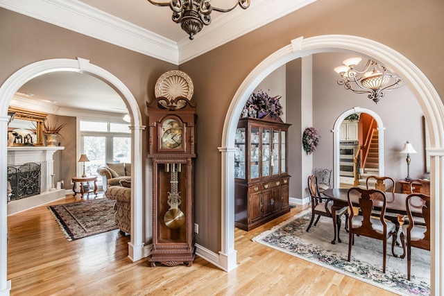 131 Grandview Cir, Gallatin, TN 37066 - entryway featuring a chandelier, arched walkways, light wood-style floors, a premium fireplace, and crown molding