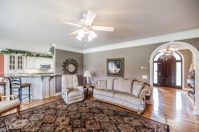 131 Grandview Cir, Gallatin, TN 37066 - living area with arched walkways, crown molding, light wood-style flooring, and a ceiling fan