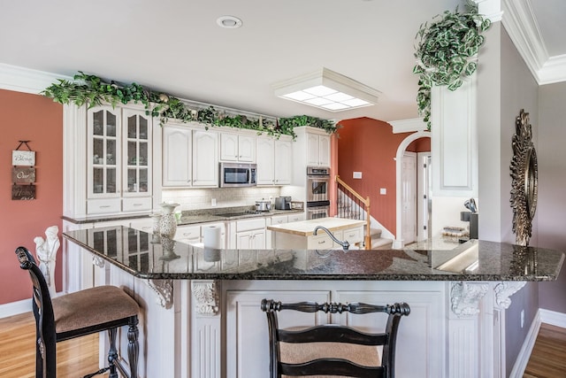 131 Grandview Cir, Gallatin, TN 37066 - kitchen featuring stainless steel appliances, a kitchen bar, ornamental molding, a kitchen island, and baseboards