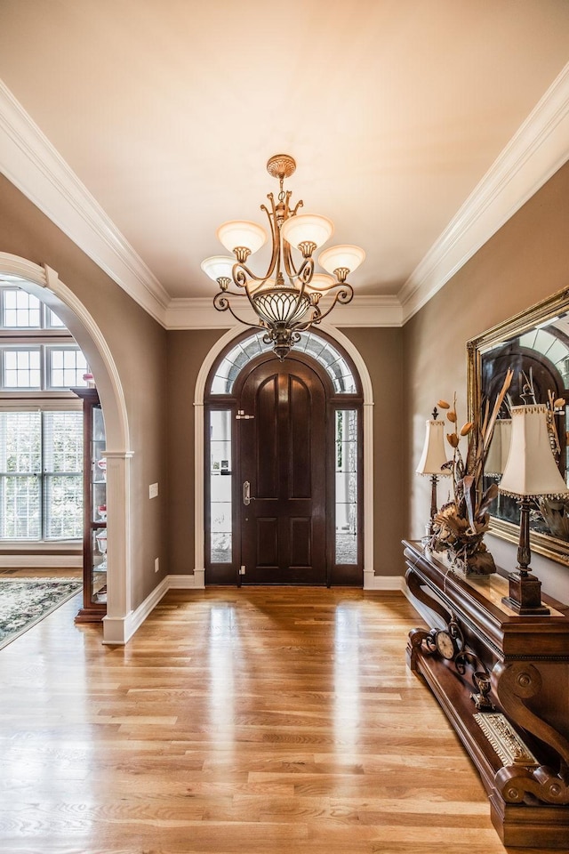 131 Grandview Cir, Gallatin, TN 37066 - entryway with arched walkways, a chandelier, light wood-style flooring, ornamental molding, and baseboards