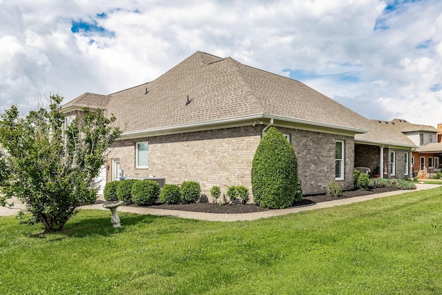 131 Grandview Cir, Gallatin, TN 37066 - view of side of home featuring a yard, brick siding, roof with shingles, and central AC