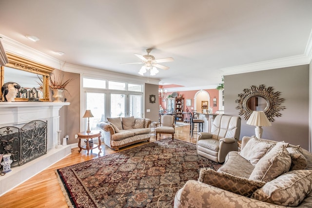 131 Grandview Cir, Gallatin, TN 37066 - living room with ceiling fan, crown molding, a fireplace with raised hearth, and wood finished floors