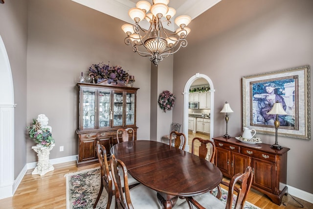131 Grandview Cir, Gallatin, TN 37066 - dining room featuring a chandelier, light wood-style floors, a high ceiling, and baseboards