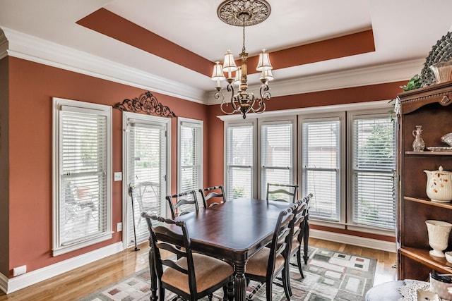 131 Grandview Cir, Gallatin, TN 37066 - dining area with a chandelier, baseboards, a raised ceiling, light wood-type flooring, and crown molding