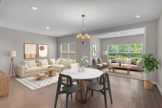 dining area featuring a chandelier, wood finished floors, recessed lighting, and baseboards