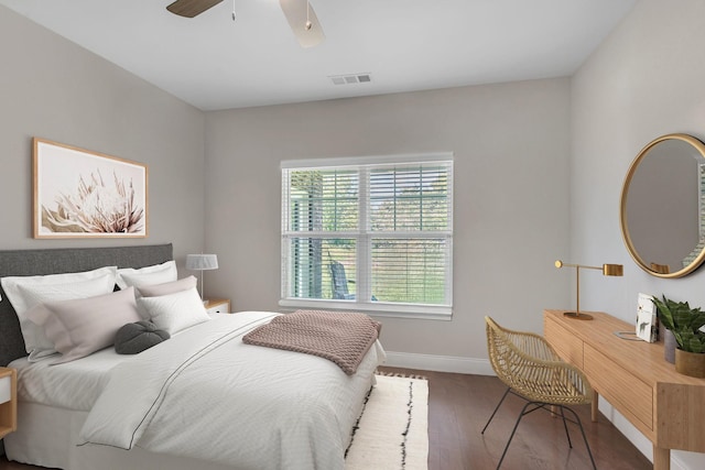 bedroom with wood finished floors, baseboards, and ceiling fan