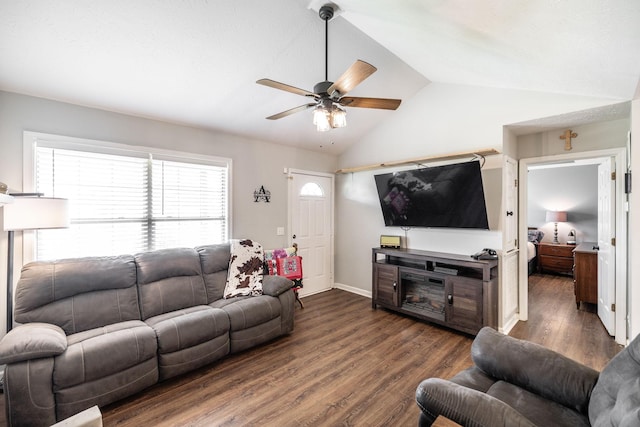 living area featuring a ceiling fan, lofted ceiling, and dark wood finished floors