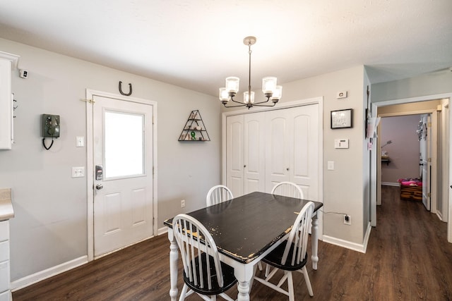 dining area with a chandelier, dark wood-style floors, and baseboards
