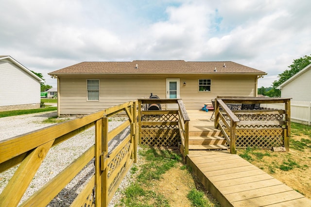 rear view of house with a wooden deck